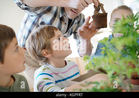 Lehrer mit Kindern im Biologieunterricht lernen über Pflanzen Stockfoto