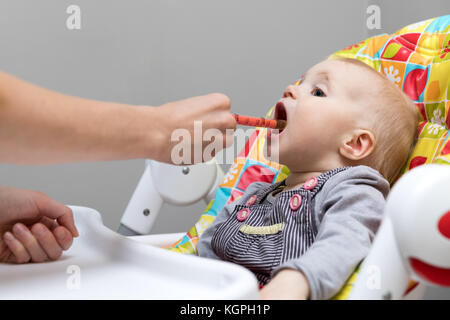 Mutter, Hustensaft mit Spritze zu ihrem kranken Kind Stockfoto