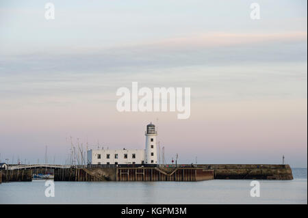 Scarborough Hafen und Leuchtturm während einer Herbst Sonnenuntergang an der North Yorkshire Stadt am Meer. Stockfoto