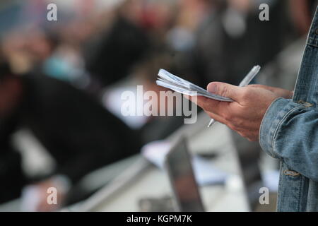 Jemand schreibt in seinem noticebook Stockfoto