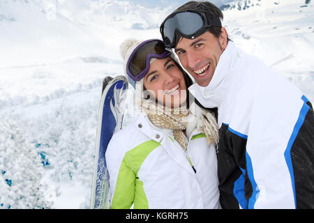 Paar stehend auf einem schneebedeckten Berg in Ski Outfit Stockfoto