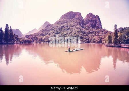 Vintage stilisierte Bild von einem Bambus-Floß auf einem See bei Sonnenuntergang in Guilin, China. Stockfoto