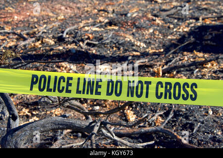 Gelbe Band Polizei Linie nicht vor ausgebrannt Struktur Schmutz zu Boden in das wilde Feuer, das durch das Napa County wütete abgeflacht Kreuz Stockfoto