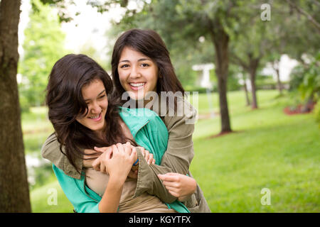 Asiatische Mutter Lachen und huging ihren Töchtern. Stockfoto
