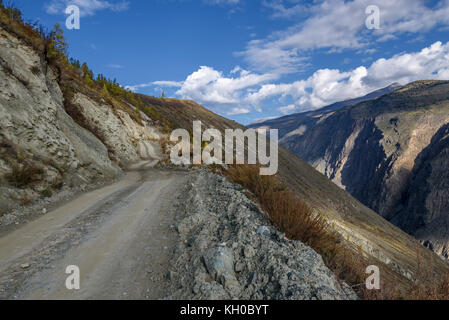 Malerischer Blick auf steile kurvenreiche Kies Berg Straße durch den Pass, Teil des Berges Serpentine, vorbei an den Hang des Berges auf einem Hintergrund Stockfoto