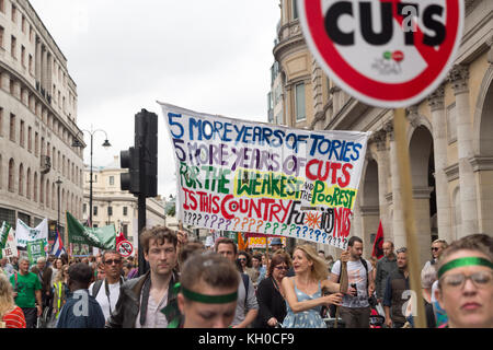 Die Demonstranten, die gegen die Sparmaßnahmen, Plakate und Banner abgebildet sind, die an eine anti-sparmassnahmen März und Demonstration im Zentrum von London. Stockfoto