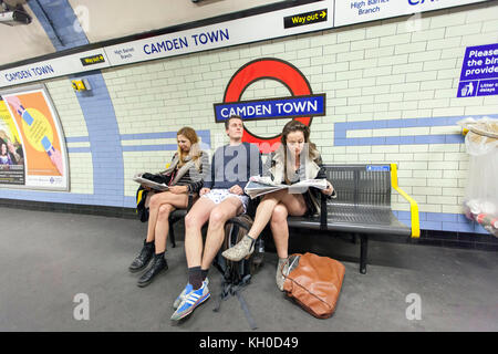 "Keine hose Tag" Teilnehmer Zeitungen lesen, während für den nächsten Zug am U-Bahnhof Camden Town warten. Stockfoto