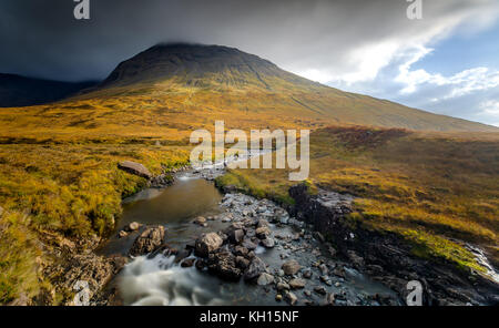 Die Sonne scheint auf die Berge bei Fairy Pools auf der Isle of Skye Stockfoto