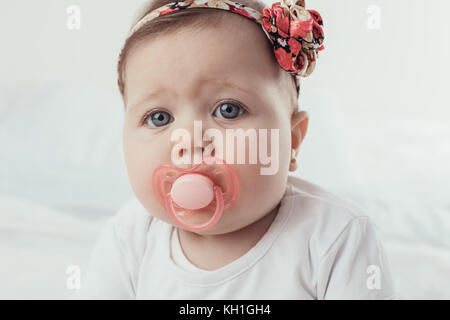 Porträt einer Smilling Baby Mädchen auf weißem Hintergrund Stockfoto