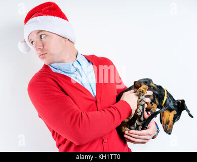 Santa Claus mit einem Dackel in den Händen Stockfoto