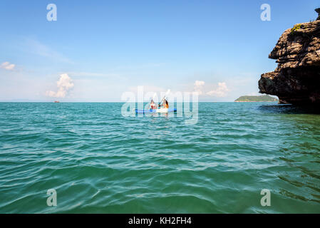 Zwei Frauen sind Mutter und Tochter. Reisen mit dem Boot mit einem Kajak gerne unter dem blauen Himmel Sommer rund um Ko Phi die schöne Natur der Meerblick und Stockfoto