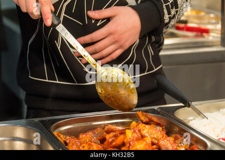 Kunden dabei helfen, sich selbst zu essen in einem Chinesischen Restaurant in China Town, London, England, UK. Stockfoto