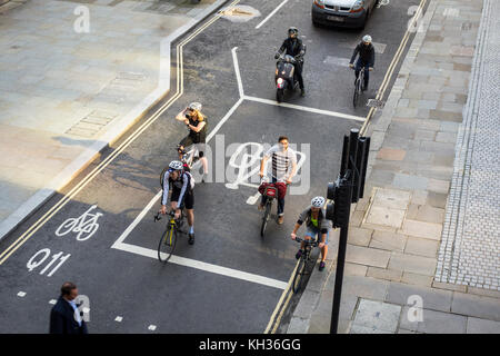 Radfahrer bei Advanced stop Linie warten (ASL), Advanced stop, Bike box Fahrbahnmarkierungen an signalisierten Kreuzung in London, Großbritannien Stockfoto