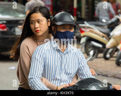 Street Fotografie in Hanoi, Vietnam. Paar auf Roller. Attraktive viettnamese Mädchen Stockfoto