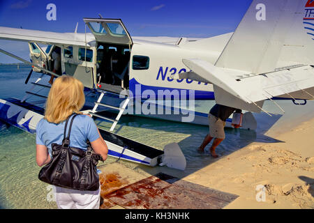 Frau boarding Sea Plane in Elbow Cay, Bahamas Stockfoto