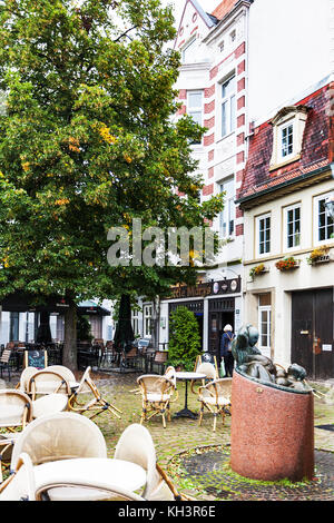 BREMEN, DEUTSCHLAND - 16. SEPTEMBER 2017: Leeres Freiluftcafé im Schnoor-Viertel bei Regen. Schnoor ist ein Stadtteil im mittelalterlichen Zentrum der Bremer Stadt Stockfoto