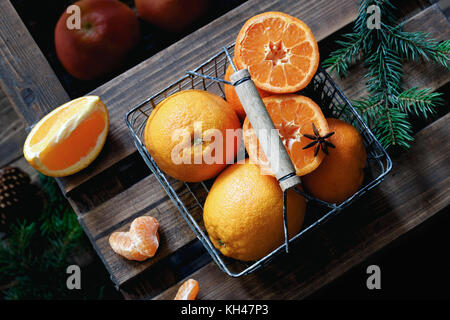 Orangen in Korb auf Holz- Hintergrund. Mandarinen, Orangen, Mandarinen für Weihnachten Stockfoto