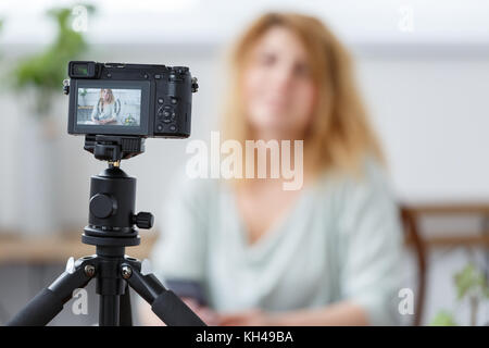 Verschwommenes Foto von Floristen Mädchen mit florarium auf Tisch. Stockfoto