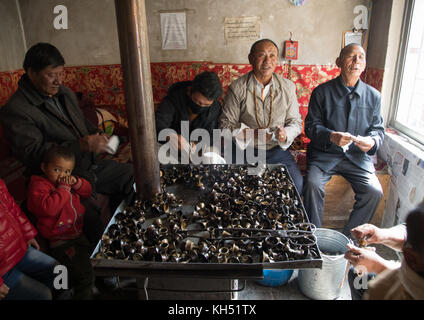 Freiwillige Reinigung butter Lampen in Shachong Monastery, Provinz Qinghai, Wayaotai, China Stockfoto