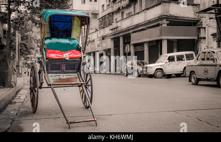 Traditionelle indische Hand herausgezogen Rikscha auf einer Straße in der Nähe der Esplanade Kolkata mit Bokeh retro Hintergrund. Stockfoto