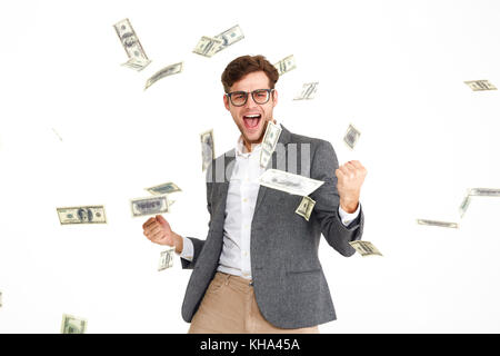 Portrait von Happy fröhliche Mann in Brillen und eine Jacke und Erfolge feiern mit fallender Geld Banknoten isoliert auf weißem Hintergrund Stockfoto