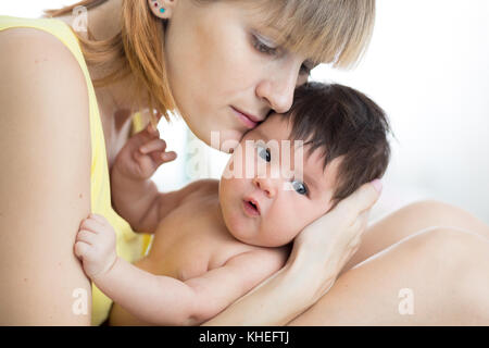 Glückliche Mutter mit neugeborenen Babys zu Hause. Familie, Kind und Elternschaft Konzept. Stockfoto