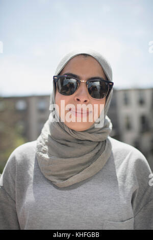 Muslimische Frau trägt ein Kopftuch und einer Sonnenbrille Stockfoto