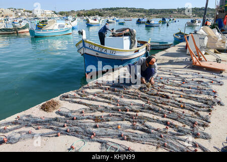 Marsaxlokk, Malta - 3 November 2017: fischer Vorbereitung der Fischernetze in der Nähe ihrer Yacht in marsaxlokk auf Malta Stockfoto