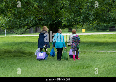 Zeit Zuhause für Menschen Wandern & verlassen Showground mit Taschen & klappbare Einkaufswagen - RHS Chatsworth Flower Show, Derbyshire, England, UK zu gehen. Stockfoto