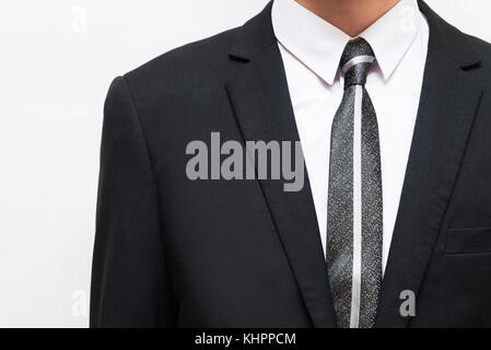 Schwarzer Anzug mit weißem Hemd und Krawatte dunkel Stockfoto