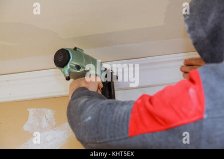 Tischler Brad mit Bolzenschußgeräten zu Stuckelemente, Verkleidung der Warnhinweis, dass alle Power Tools Stockfoto