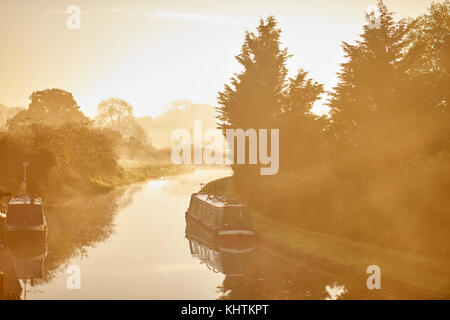 Herbst Nebel Nebel Cheshire, Tiverton, Tarporley. Narrowboats festgemacht an der Seite des schattigen Eiche Pub auf dem Shropshire Union Canal Stockfoto