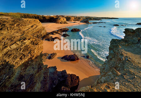 Blick auf die Küste auf den natürlichen felsigen Strand mit beigefarbenem Sand und schieferartigen Klippen Stockfoto