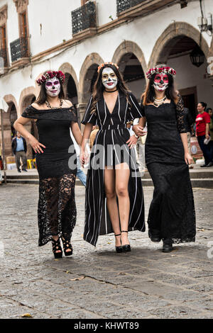 Mexikanische Teenager in La Calavera Catrina und Dapper Skelett Kostüme für den Tag der Toten oder Día de Muertos Festival 31. Oktober 2017 in Patzcuaro, Michoacan, Mexiko gekleidet. Das Fest wird seit dem aztekischen Reich gefeiert feiert Vorfahren und verstorbene Lieben. Stockfoto