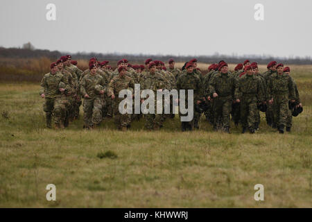 KOVIN, Serbien - fallschirmjäger von 173Rd Airborne Brigade März zusammen mit dem Serbischen Fallschirmjäger nach Durchführung einer in der Luft springen während der Übung Double Eagle 17. Übung Double Eagle ist eine multi-nationale Unternehmen Airborne insertion Übung, die die Beziehung zwischen den USA und Serbien zu verbessern und die regionale Sicherheit zu stärken. Stockfoto