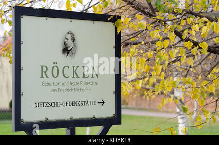 Luetzen, Deutschland. November 2017. Ein Schild weist auf die Gedenkstätte für den Philosophen Friedrich Wilhelm Nietzsche (1844–1900) in Roecken, einem Landkreis von Luetzen, am 15. November 2017. An Nietzsches Leben und Werk erinnert ein Gedenkort mit dem Kunstwerk, einem kleinen Museum, seinem Geburtshaus, dem Taufhaus aus dem 12. Jahrhundert und dem Grab. Quelle: Sebastian Willnow/dpa-Zentralbild/dpa/Alamy Live News Stockfoto