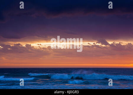 Ferne Wolken Hintergrund Wellen am Strand Stockfoto