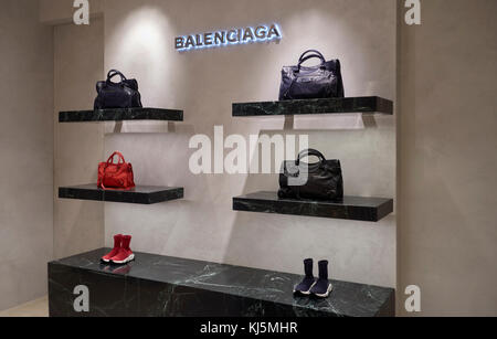 Elegante Fashion Store, Balenciaga Taschen und Schuhe aus Leder in den Regalen Stockfoto