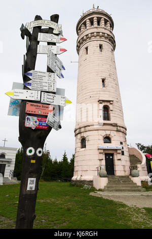 Aussichtsturm aus Stein und Wegmarkierungen mit Pfeilschildern auf dem Gipfel des Wielka Sowa, dem höchsten Gipfel des Eulengebirges in Polen Stockfoto