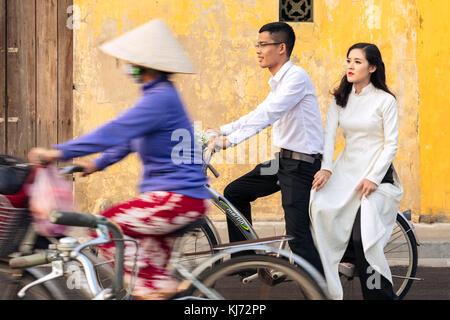 Jungen Brautpaar auf einem Fahrrad in der von der Unesco zum Weltkulturerbe historisches Zentrum von Hoi An, Vietnam Stockfoto