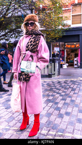 Ganzkörperportrait einer trendigen jungen Frau in rosa, Soho, London, England, Großbritannien. Stockfoto