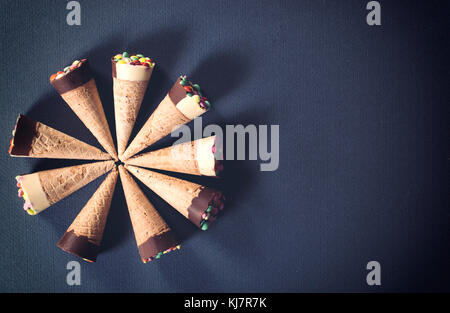 Eis in Cornet von oben auf grauem Hintergrund mit Leerzeichen, selektiver Fokus Stockfoto