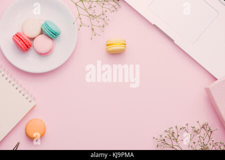 Morgendlichen Tasse Kaffee, Kuchen Macaron, Geschenk oder präsent, und Blume auf Licht Tabelle von oben. schöne Frühstück. Flacher Stil legen. Stockfoto