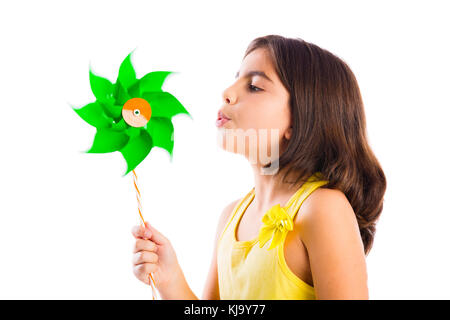 Schöne Mädchen bläst eine Kunststoff Windmühle Stockfoto
