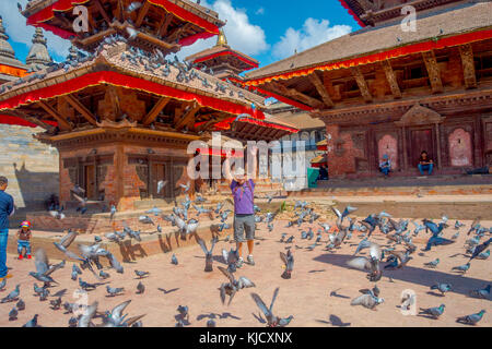 Kathmandu, Nepal Oktober 15, 2017: Nicht identifizierte Personen auf dem Platz stehen mit einem Schwarm Tauben am Durbar Square in der Nähe von Alte hinduistische Tempel in Kathmandu, Nepal Stockfoto