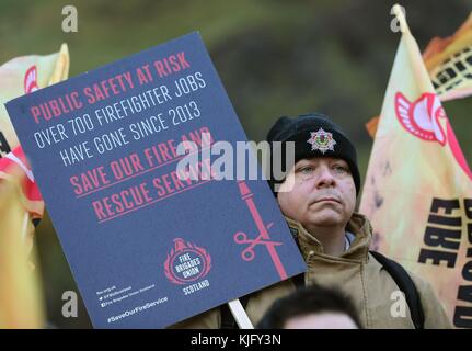 Feuerwehrleute hören dem schottischen Labour-Führer Richard Leonard zu, als er sich bei einer Fire Brigade Union Scotland Kundgebung vor dem schottischen Parlament in Edinburgh an Feuerwehrleute wendet. Stockfoto