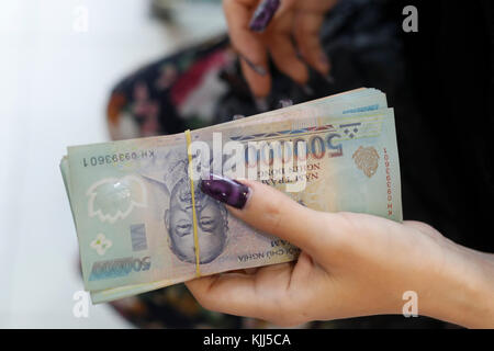 Vietnamesische Währung, der Dong. Frau mit Banknoten. Ho Chi Minh City. Vietnam. Stockfoto