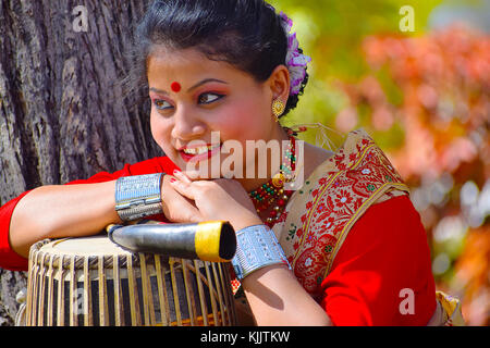 Assamesisch Mädchen in traditioneller Kleidung mit einem Dhol (Trommel), Pune, Maharashtra posieren. Stockfoto