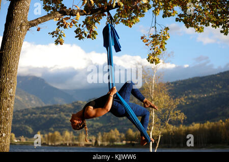 Frau tun Pose der Antenne Yoga mit Hängematte im Freien. Saint-Gervais. Frankreich. Stockfoto