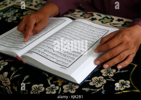 Saigon Zentralmoschee. Muslimischen mann Lesen eines arabischen Koran oder Koran. Close-up. Ho Chi Minh City. Vietnam. Stockfoto